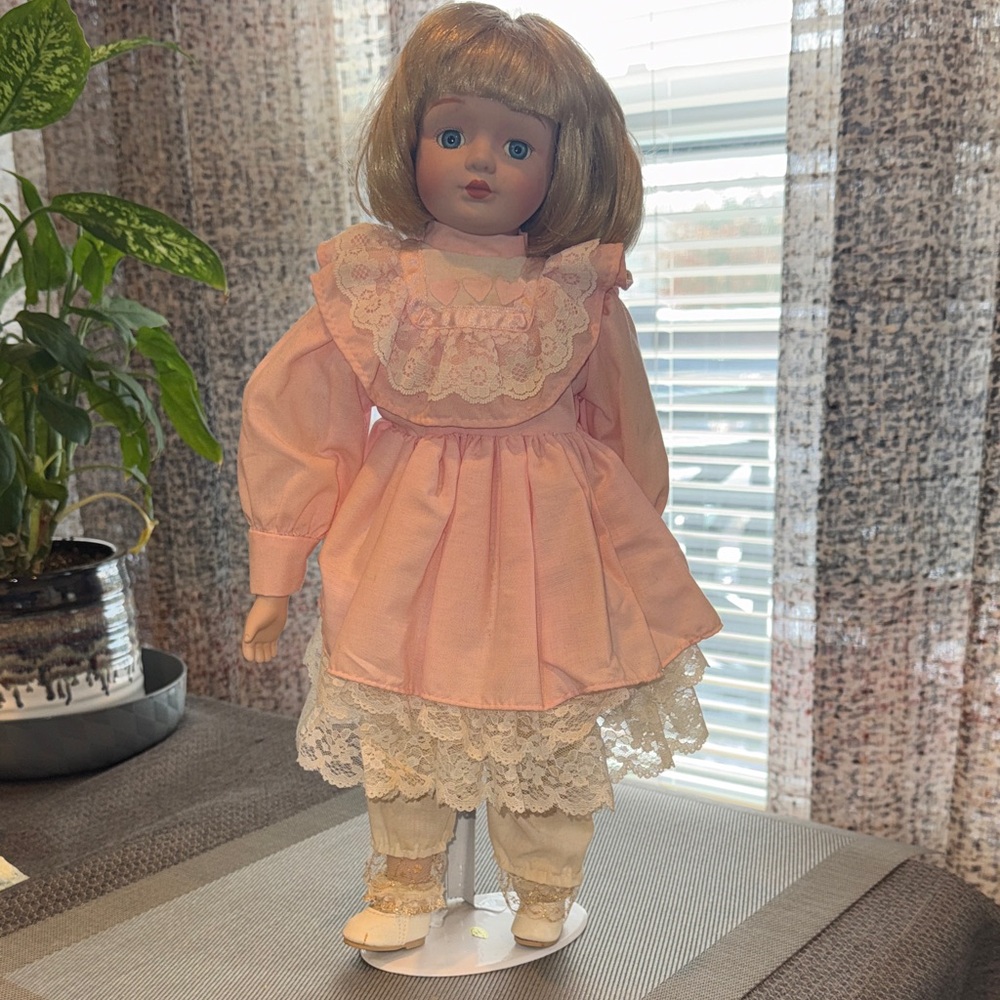 Vintage Porcelain Doll Wearing Pink Dress with White Lace. 16 Inches tall.